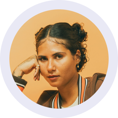 Headshot of a woman with two hair buns in a white circle